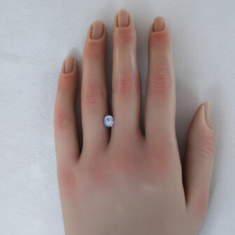 A 1.06 carat pale blue-purple sapphire shown on a lady's hand.