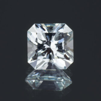An image of a square cut, light blue aquamarine against a dark background.