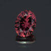 This picture shows a closeup view of a 1.68 carat oval rhodolite garnet.