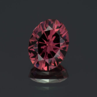 This picture shows a closeup view of a 1.68 carat oval rhodolite garnet.