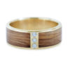 An image of a 14k gold and wood ring inlaid with Bethlehem olive wood and diamonds.
