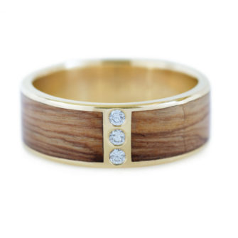 An image of a 14k gold and wood ring inlaid with Bethlehem olive wood and diamonds.