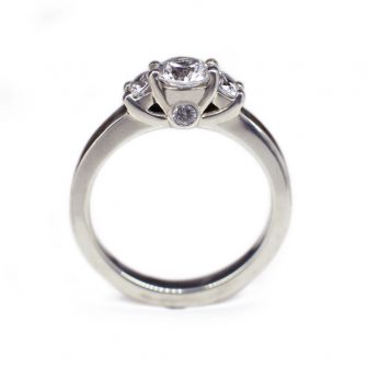 A profile view of a lady's wood engagement ring with a hidden gemstone