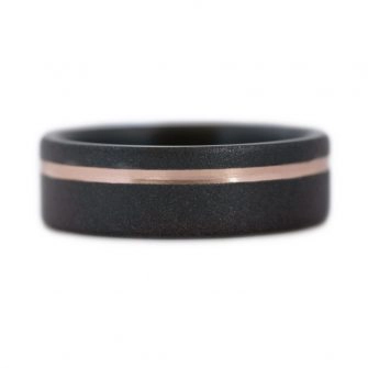 A black zirconium wedding ring with a 14k rose gold ring.