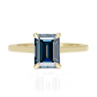 A picture of an emerald cut blue moissanite engagement ring.