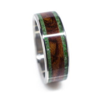 A straight-on view of our bubinga wood ring with jade inlay, showcasing the smooth integration of metal and wood.