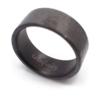 A black zirconium ring with to infinity engraved on the inside of the band.