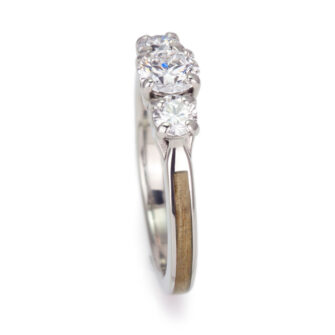 Modern design meets nature in this engagement ring with three diamonds and cedar wood.