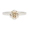 A picture of a champagne moissanite engagement ring with lab-grown diamond pavé setting.