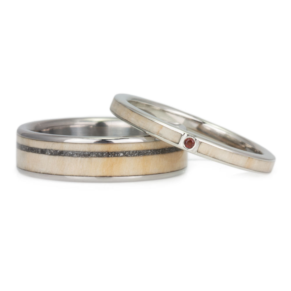 An image of a handcrafted wooden wedding band set, inlaid with customer-provided wood from their Christmas tree.