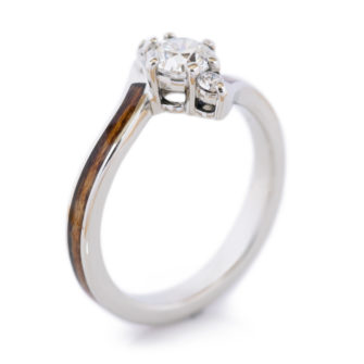 A product photo of a wooden engagement ring with diamonds.