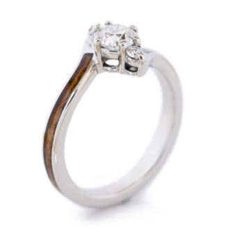 A product photo of a wooden engagement ring with diamonds.