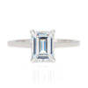 An image of an emerald cut solitaire moissanite engagement ring.