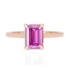 A picture of a pink emerald cut moissanite engagement ring.