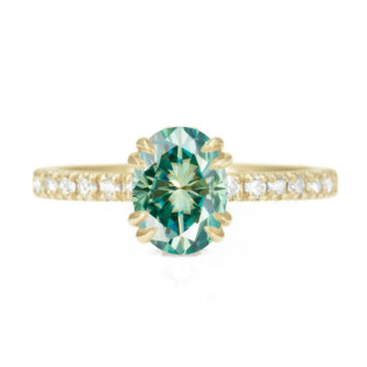 An image of a green oval cut moissanite engagement ring.