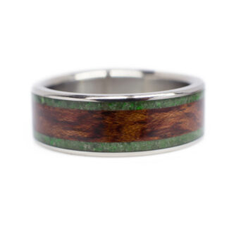 Close-up view of our handcrafted bubinga & jade wood and metal ring, highlighting the rich textures and seamless craftsmanship.