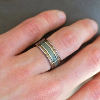 Koa wood ring shown on a hand
