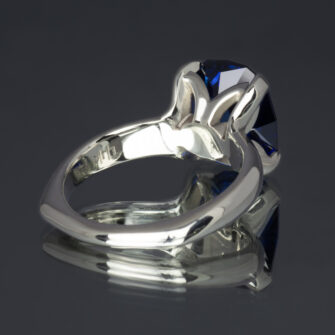 A close-up showing the back and inside of this lab-created blue sapphire 14k white gold ring.