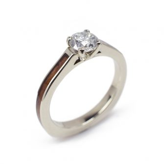 A diamond and wood engagement ring made with red wood