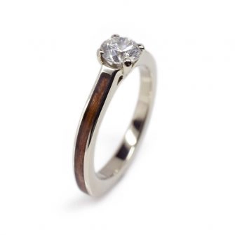 A side shot of a diamond and wood engagement ring