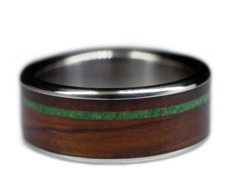 A wooden ring made with a titanium liner and a wood and jade inlay