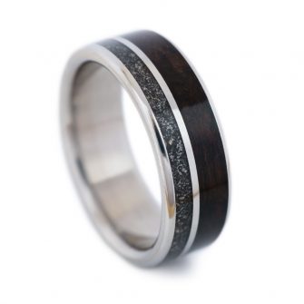 An image of a ring made from meteorite and walnut