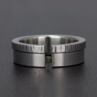 A tension set diamond cube ring made in stainless steel.