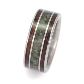 The natural beauty of our koa wood and emerald wedding band, emphasizing its organic appeal.