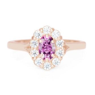 A picture of an oval cut pink moissanite engagement ring in 14k rose gold.