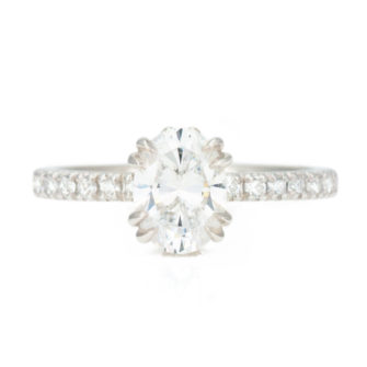 An image of an oval cut moissanite engagement ring set with a Charles and Colvard moissanite.