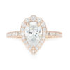 A picture of a 14k rose gold pear cut moissanite engagement ring.