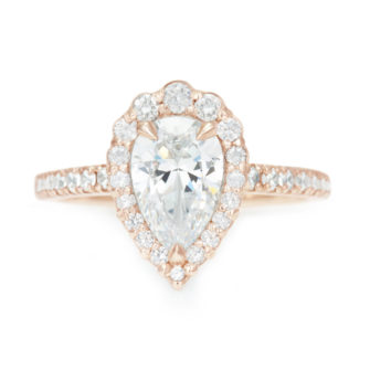 A picture of a 14k rose gold pear cut moissanite engagement ring.