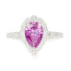 An image of a pink pear cut moissanite engagement ring with diamond accent stones.