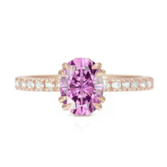 An image of a pink moissanite engagement ring in 14k rose gold.