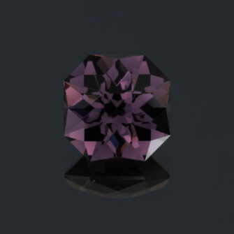 An image of a large deep purple spinel, square cut.