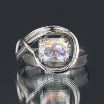 A rainbow moonstone ring with a sculpted and flowing band.