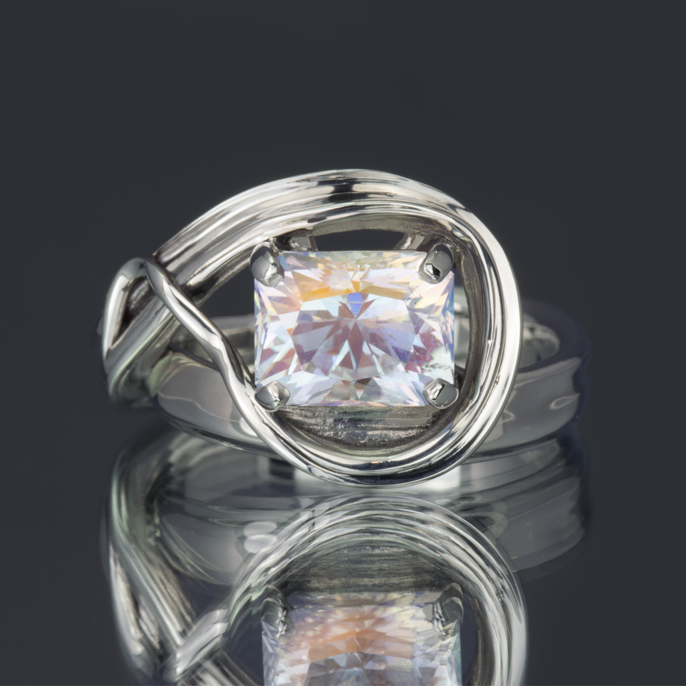 A rainbow moonstone ring with a sculpted and flowing band.