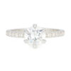 An image of a round cut moissanite engagement ring featuring a 1.30 carat diamond equivalent center stone.