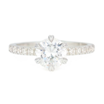 An image of a round cut moissanite engagement ring featuring a 1.30 carat diamond equivalent center stone.