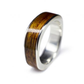 A men's square wedding ring inlaid with wood and made in white gold