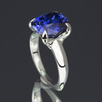 A stunning statement ring featuring a large, vibrant lab-grown blue sapphire elegantly mounted in gleaming 14k white gold.