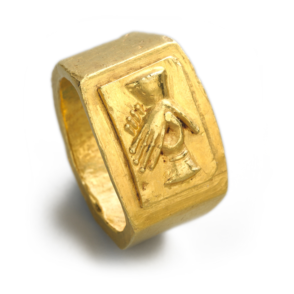 A 3rd century Roman betrothal or wedding ring. It is a wide band with two clasping hands embossed on the top.