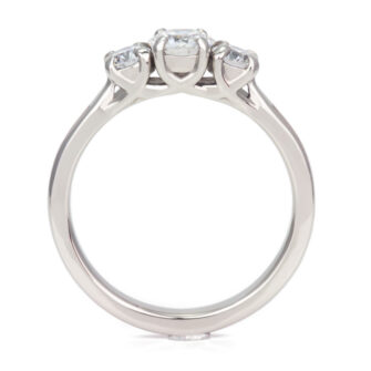 A front profile picture of our three stone engagement ring with diamond settings and cedar wood details.