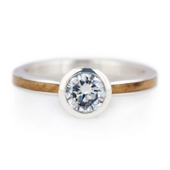 A picture of a maple wood engagement ring set with a 0.80 carat diamond.