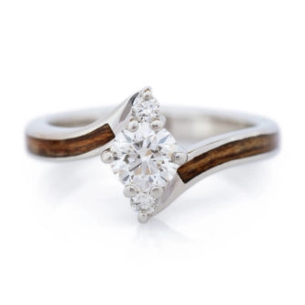 An image of a wood and diamond engagement ring, made with Shedua wood.