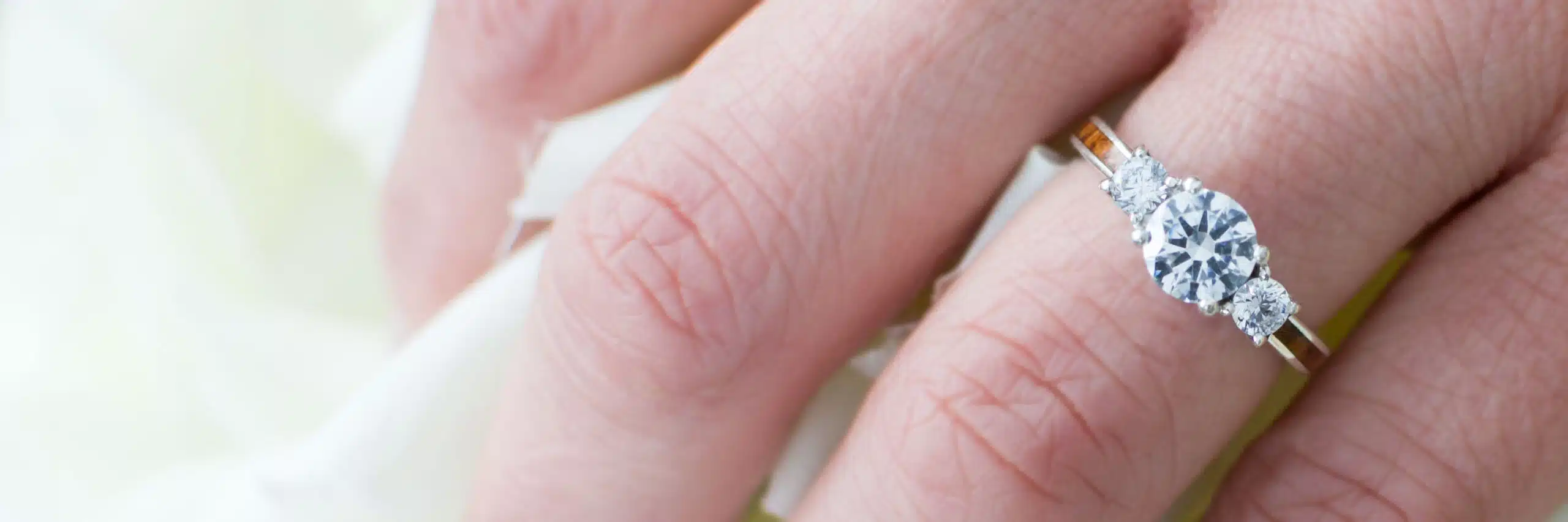 A banner image showcasing a wood engagement ring, set against a serene natural backdrop, highlighting the unique textures and warm tones of the wood.