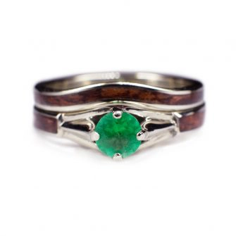 A wood engagement ring for a woman, made with an emerald and white gold