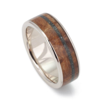 A 14k gold and wood ring inlaid with meteorite.