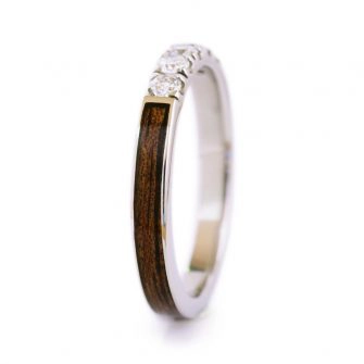 An image of a koa wood ring with diamonds.