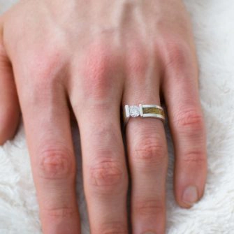 Men's engagement ring on hand.